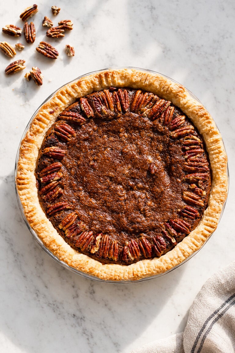 Gluten-free chocolate pecan pie with whole pecans decorating the top