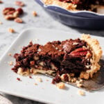 Gluten-free chocolate pecan pie with whole pecans decorating the top