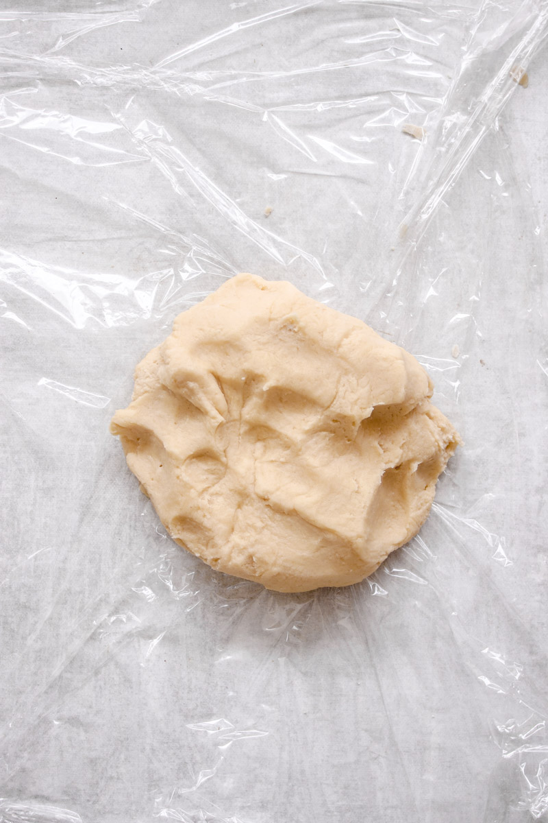 image of a pie dough on plastic wrap