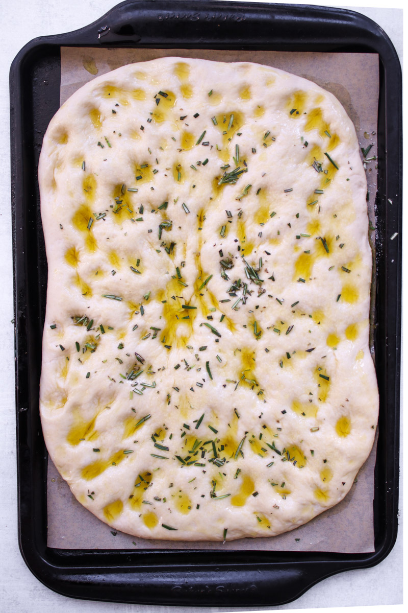 overhead image of a focaccia dough ready to bake