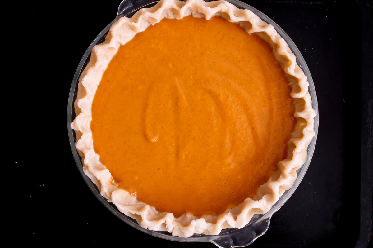 overhead image pumpkin pie on a baking sheet