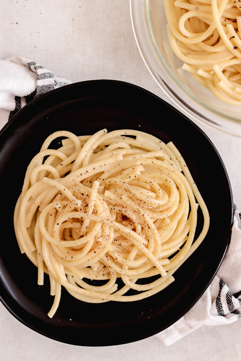 image of pasta on a black plate. 