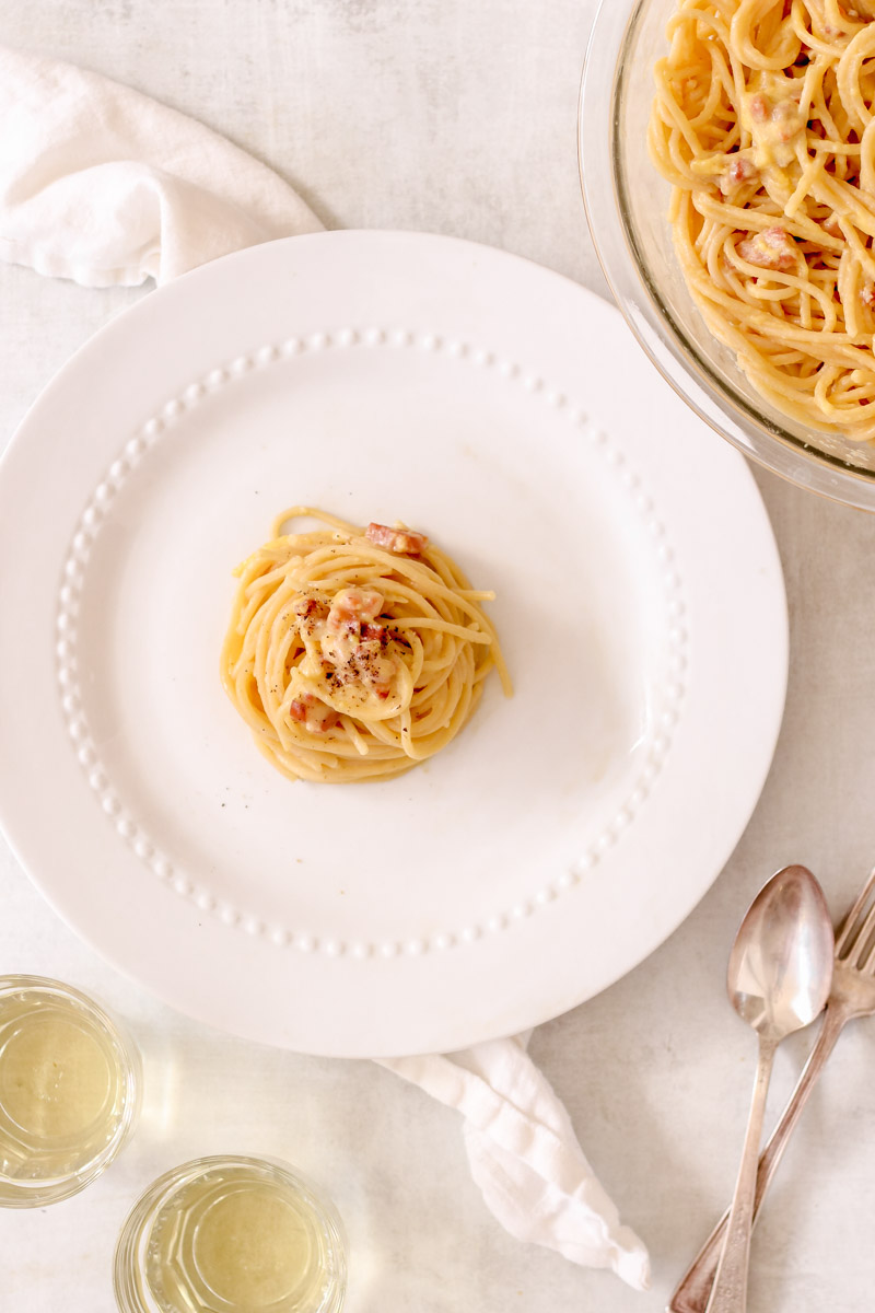 overhead image of traditional spaghetti alla carbonara on a white plate