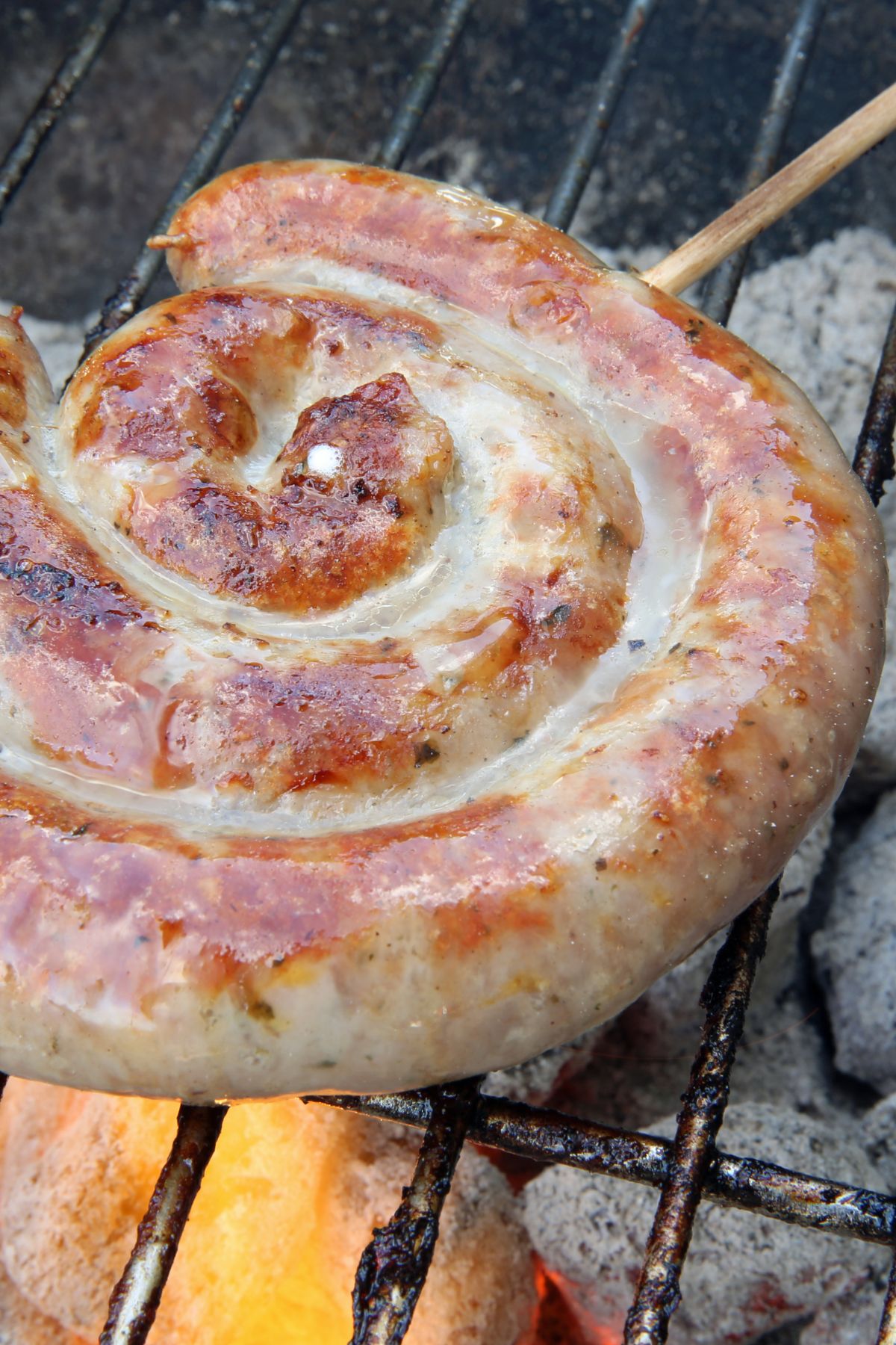 photo of salsiccia grilling on a grill.