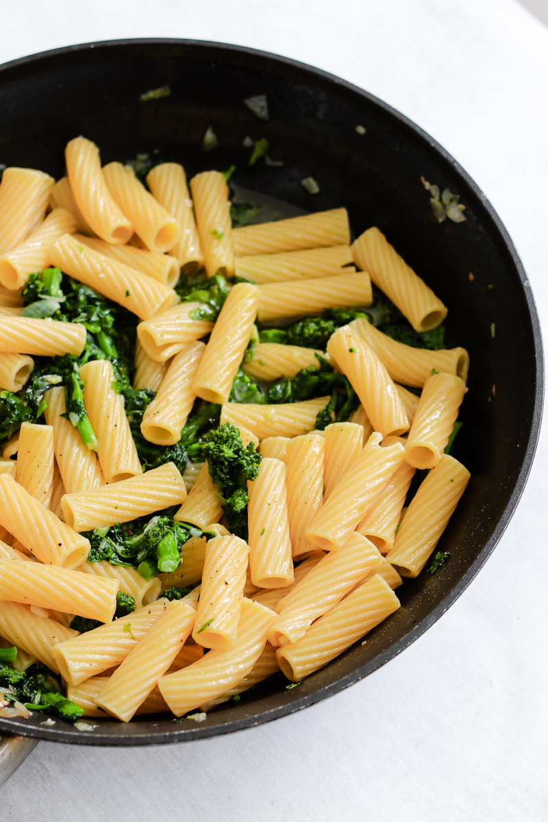 image of pasta in a skillet with rapini. 