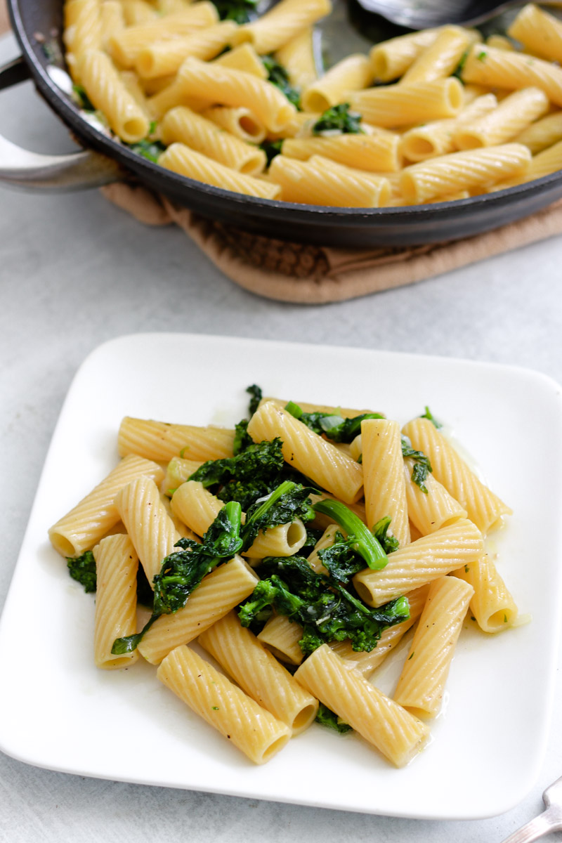 image of pasta with rapini on a white plate. 