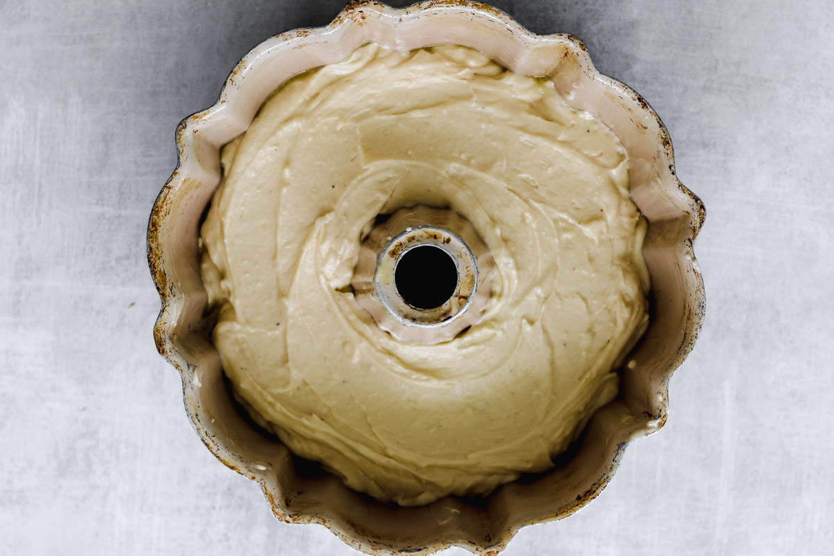 image of a baked cake in Bundt pan and lemons in background.