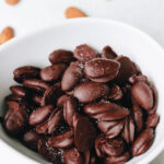 chocolate covered almonds in a bowl.