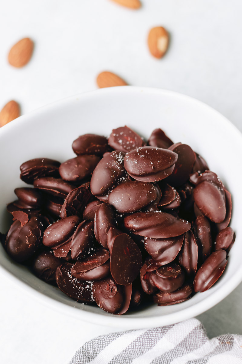 chocolate covered almonds in a bowl.