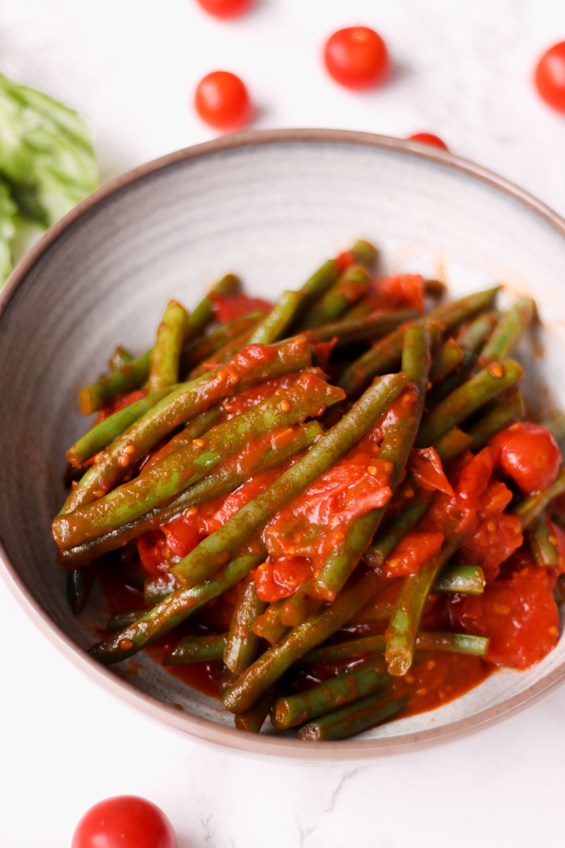 overhead image of green beans in tomato sauce. 