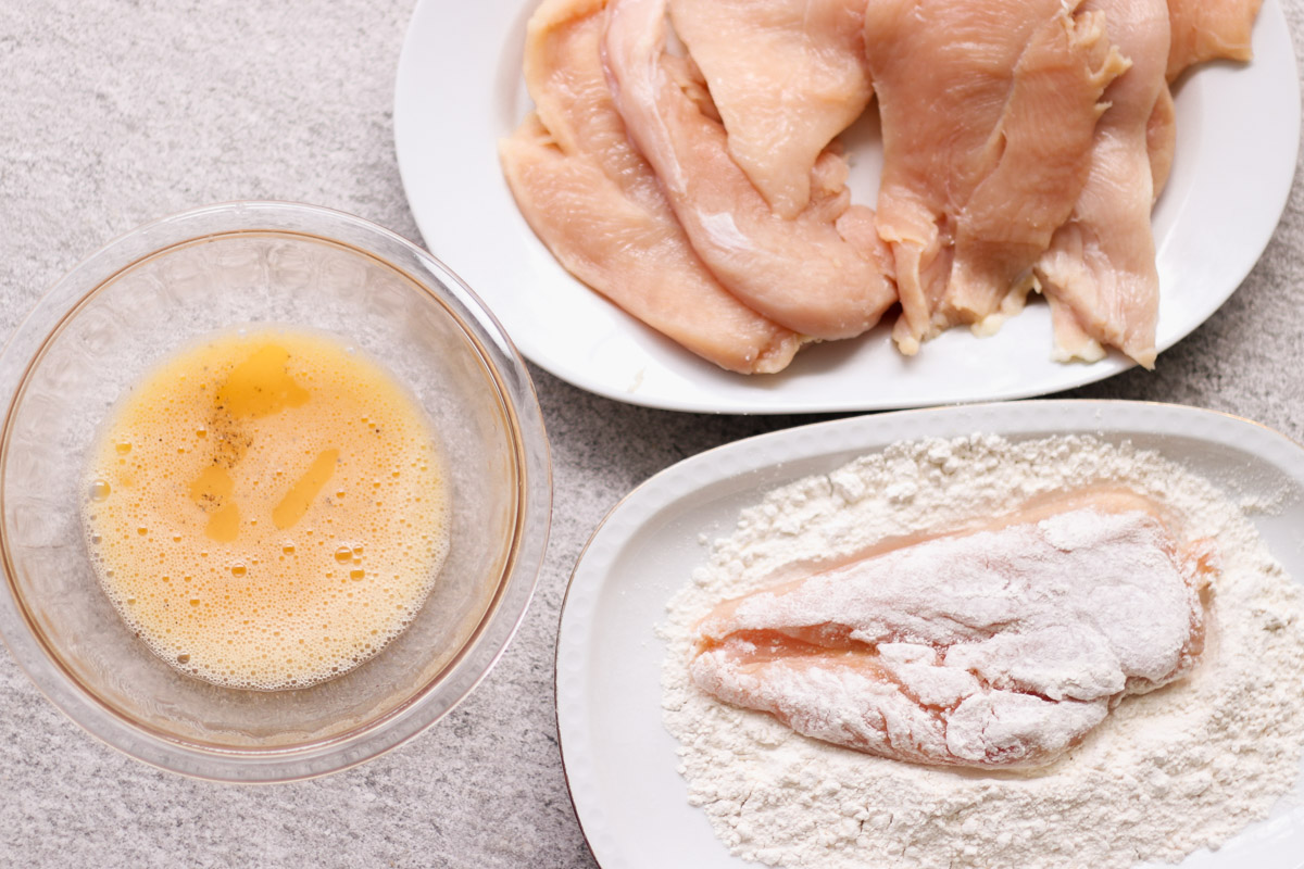 overhead image of dredging chicken breasts and egg wash. 