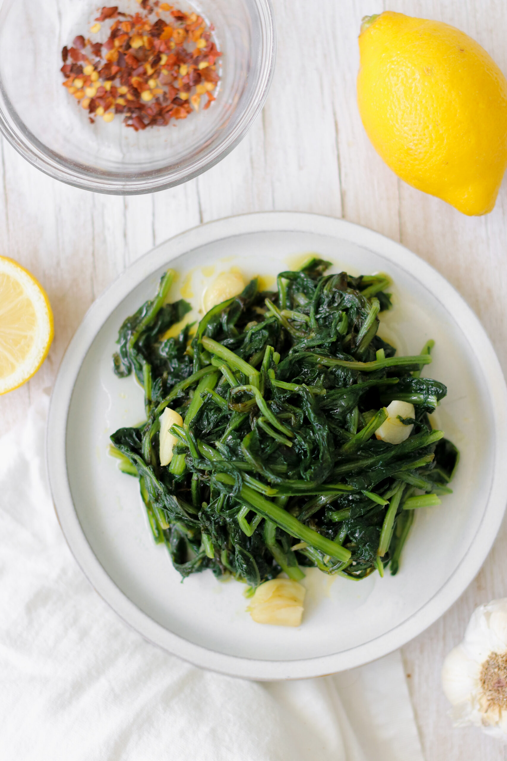 dandelion greens on a white dish.