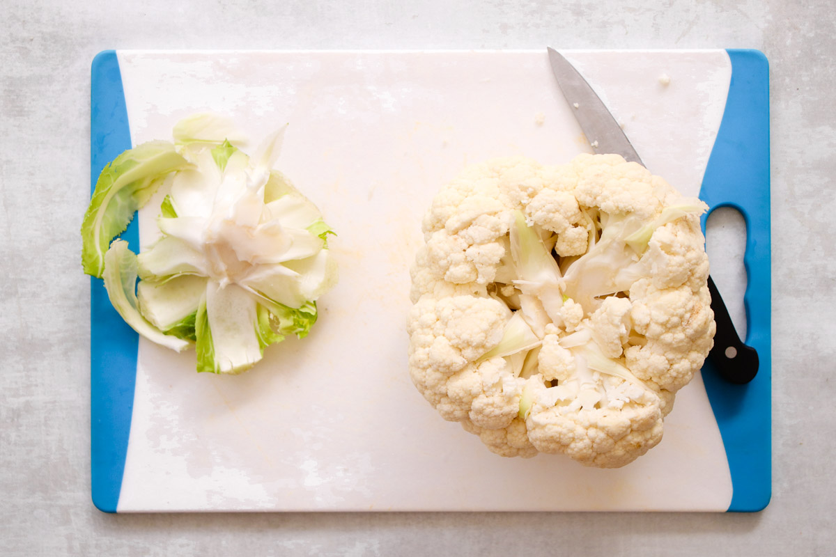overhead image of prepping a large cauliflower floret. 