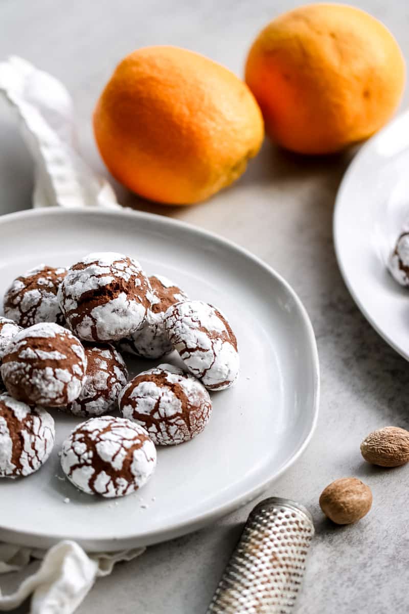 overhead image of chocolate meatball cookies on a white plate.