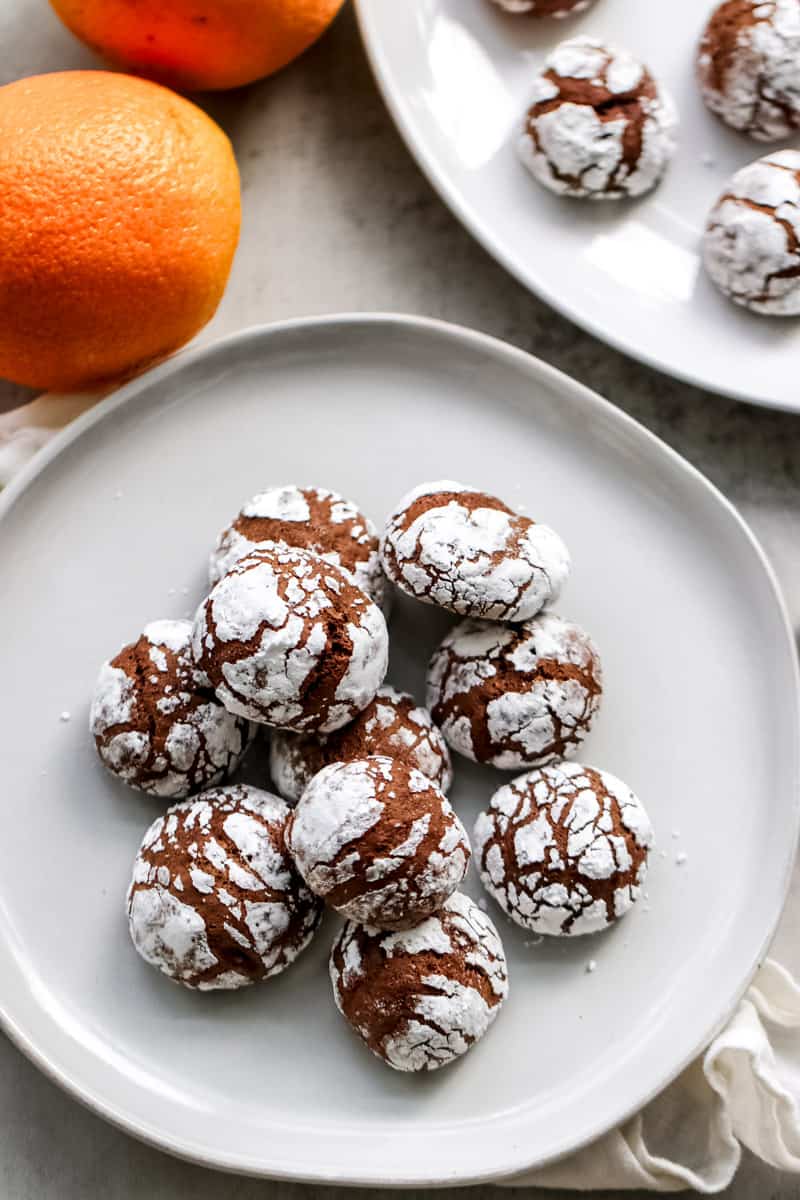 overhead image of Italian chocolate spice cookies with oranges in the background. 