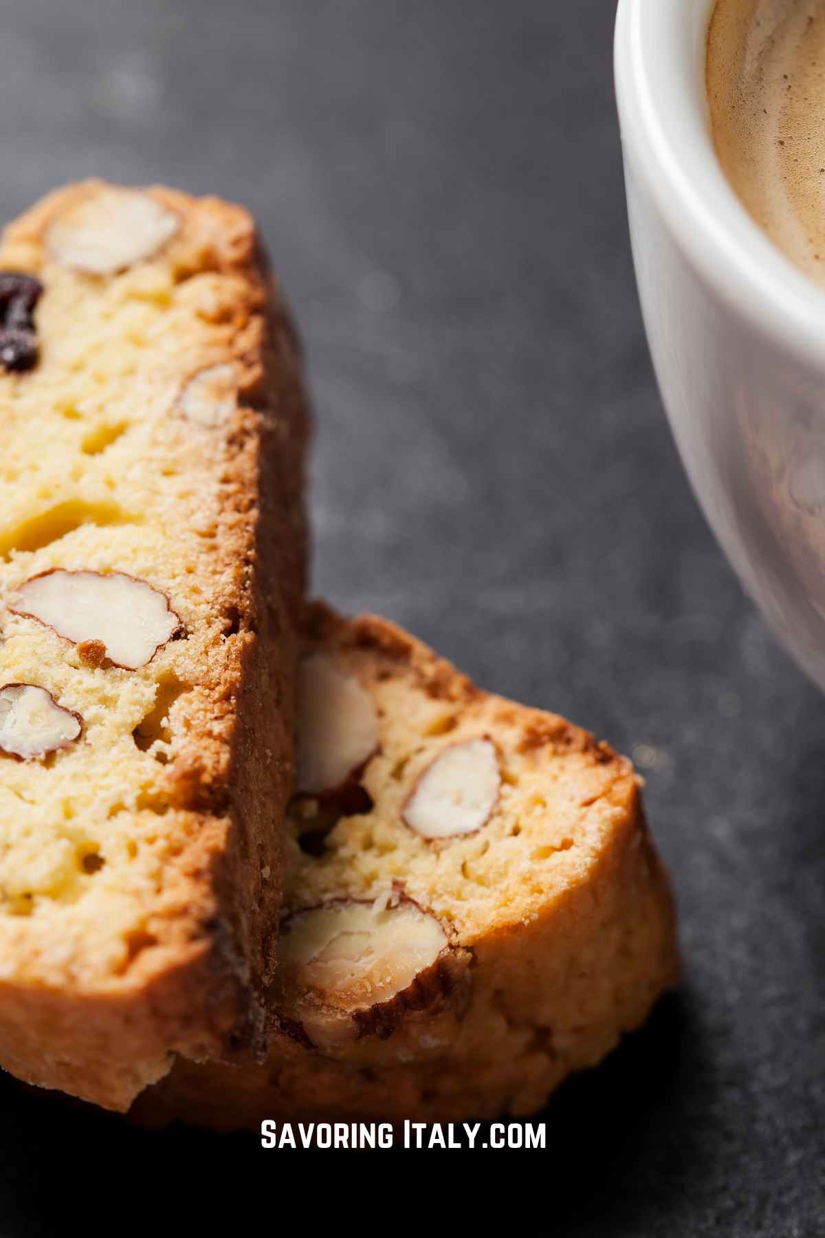 Two delicious biscotti, Roman style, next to a cup of cappuccino.