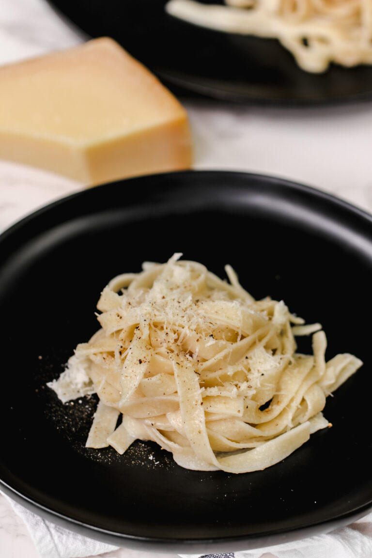 fettucine alfredo on a black dish.