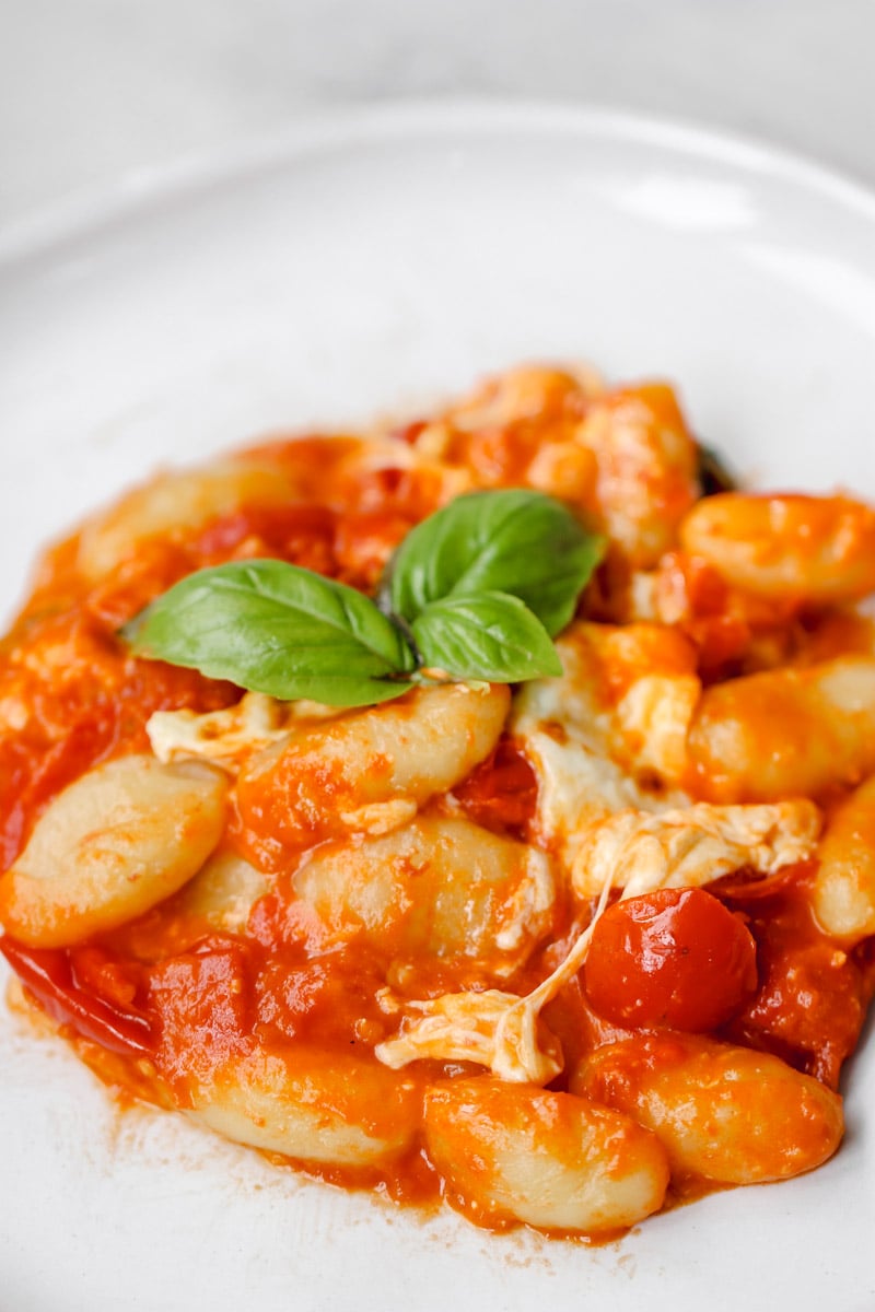 close-up image of gnocchi alla sorrentina on a white plate.