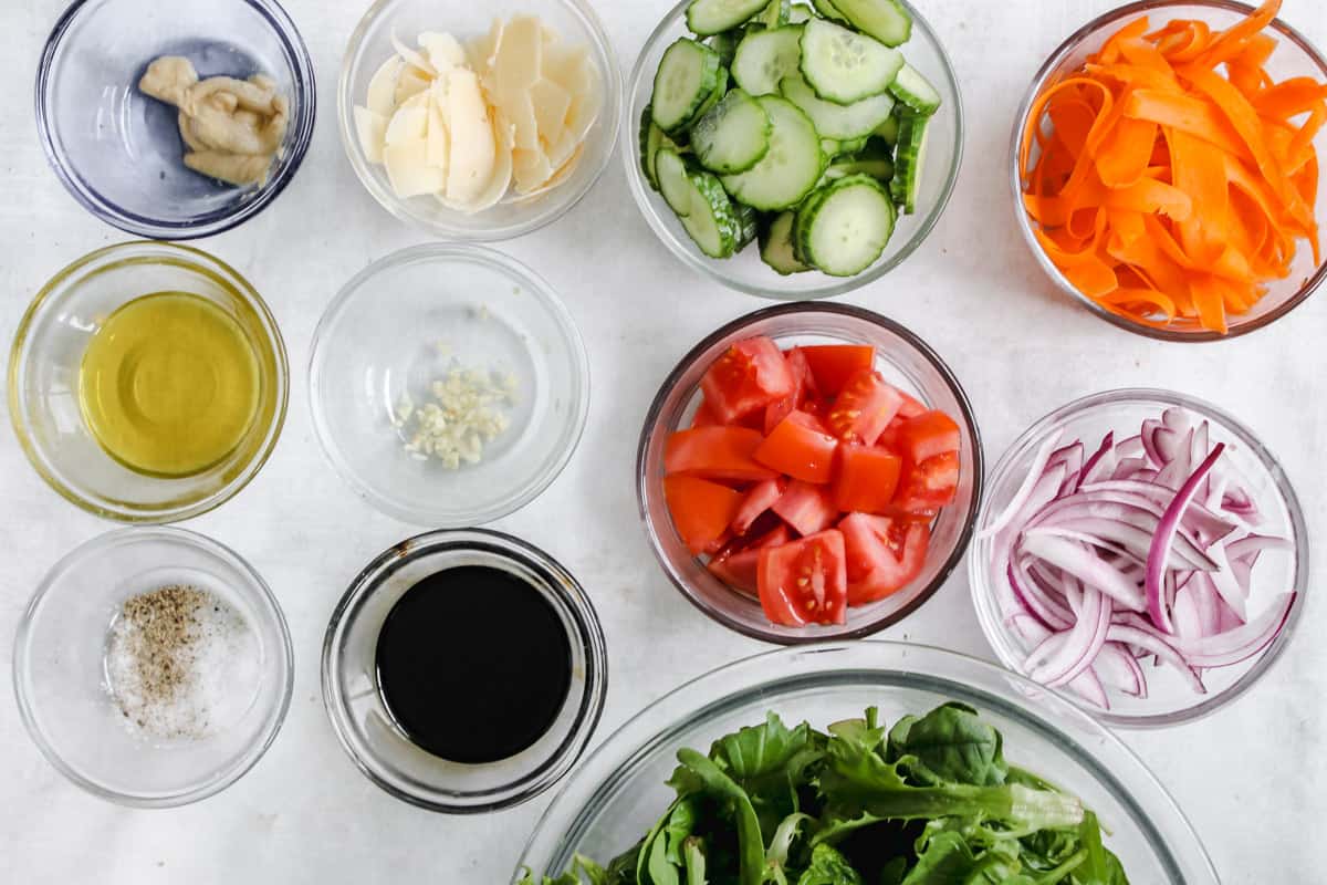overhead image of ingredients to make a mixed green salad. 