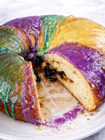 A King Cake with rich purple icing, perfect for festive celebrations.