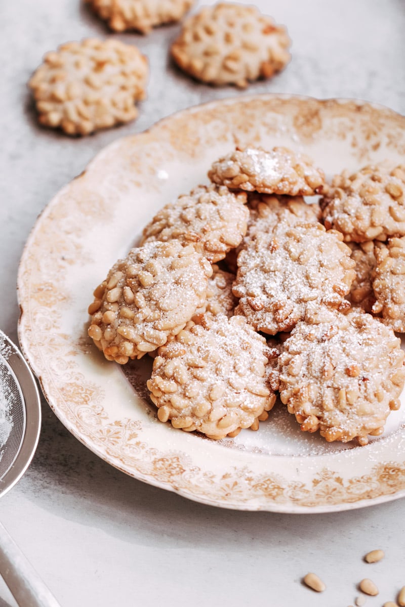 close up image of Sicilian pine nut cookies on a serving dish.