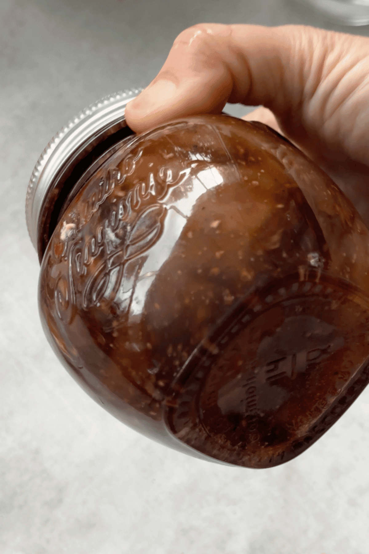 close up image of salad dressing being shaken up.