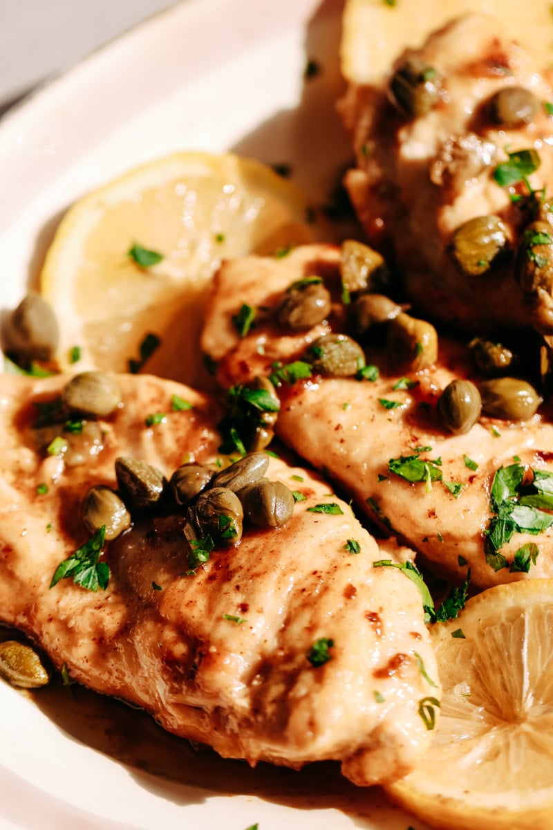 close-up image of chicken cutlets on a serving plate.