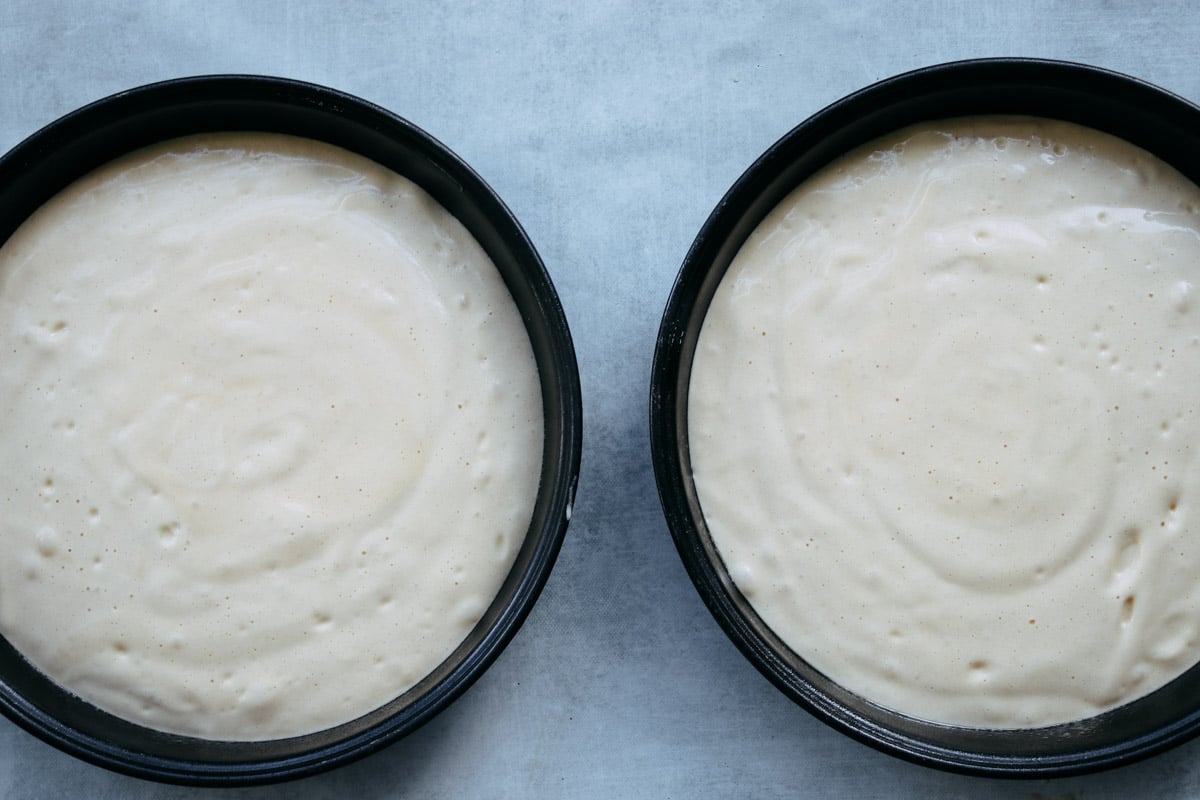 overhead image of pan di spagna batter in two cake pans.