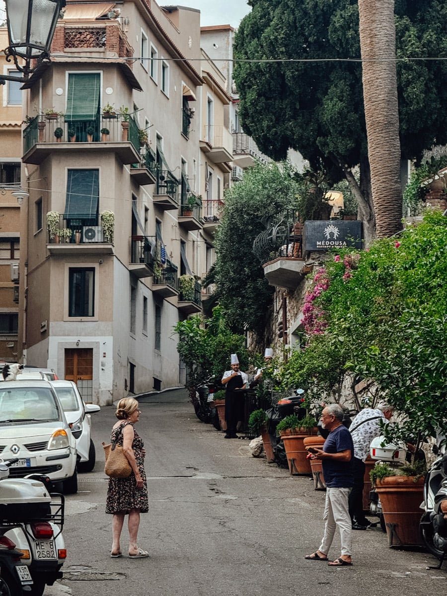 People talking in Taormina, Sicily.