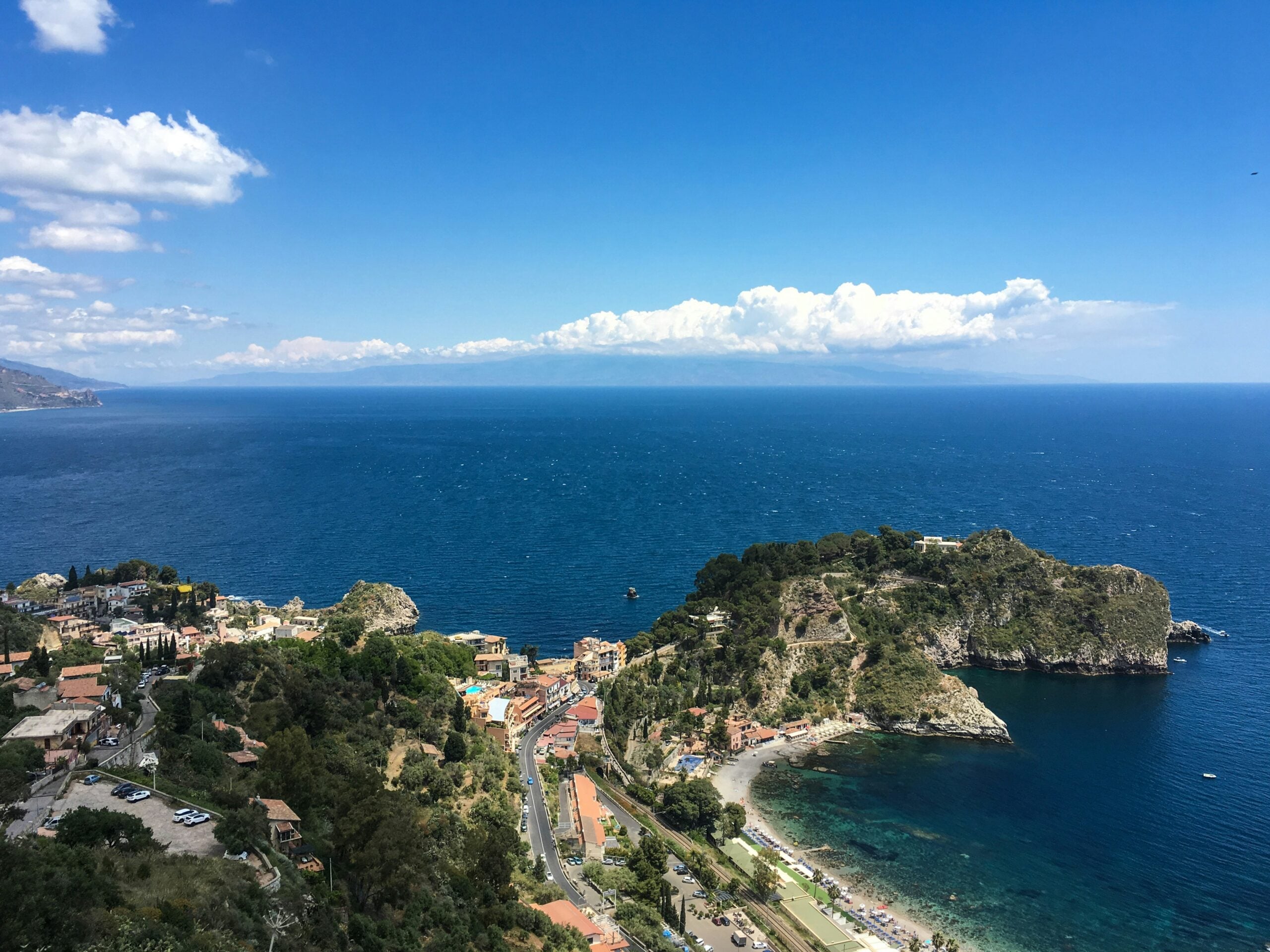 The stunning Taormina coastline in Sicily features a captivating blend of rugged cliffs, golden sandy beaches, and the crystal-clear waters of the Mediterranean Sea. This picturesque shoreline is dotted with lush greenery and charming coastal towns, creating a scenic paradise that epitomizes the natural beauty and allure of Taormina. The dramatic landscape and serene sea views make the Taormina coastline a must-visit destination for travelers seeking a perfect mix of relaxation and adventure in Sicily.