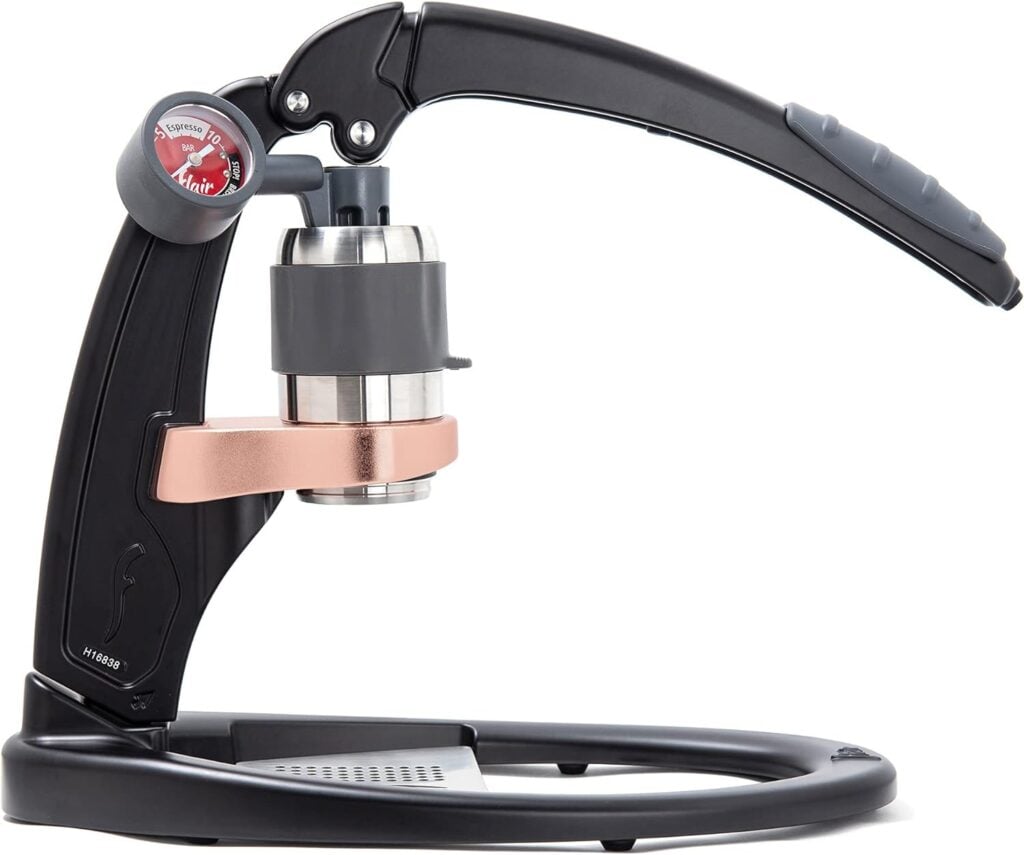 A high-resolution photograph of the Flair Espresso Maker PRO 2 set against a clean white background. This elegant manual espresso maker features a robust, stainless steel brewing head and a sleek, ergonomic design with a black and chrome finish. The PRO 2 model includes an upgraded pressure gauge, a custom bottomless portafilter, and a stainless steel tamper, enhancing its professional-level performance. Known for its ability to produce high-quality, barista-grade espresso, the Flair PRO 2 is perfect for coffee aficionados who value precision and craftsmanship. Ideal for use with traveling coffee makers, it allows you to enjoy exceptional espresso anywhere, combining portability with superior brewing capabilities.