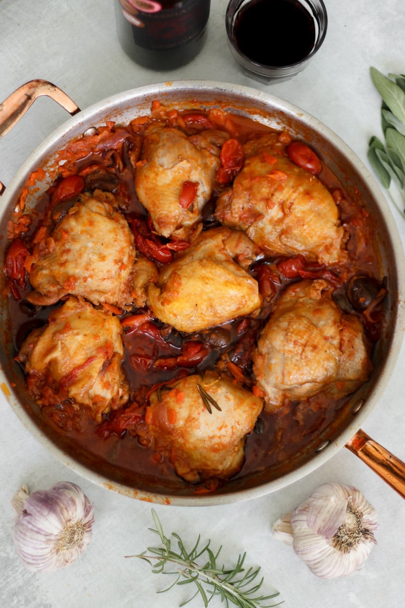 overhead image of chicken cacciatore in a skillet.