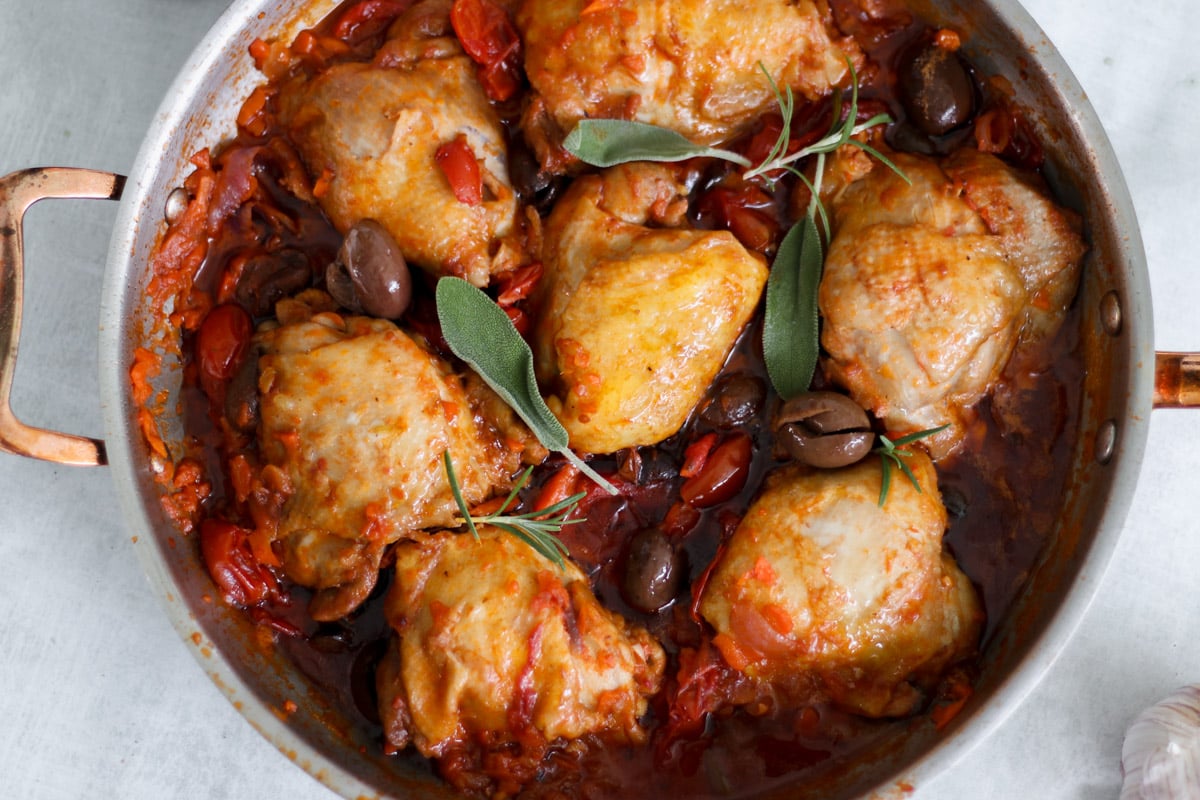 overhead image of chicken cacciatore in a skillet.