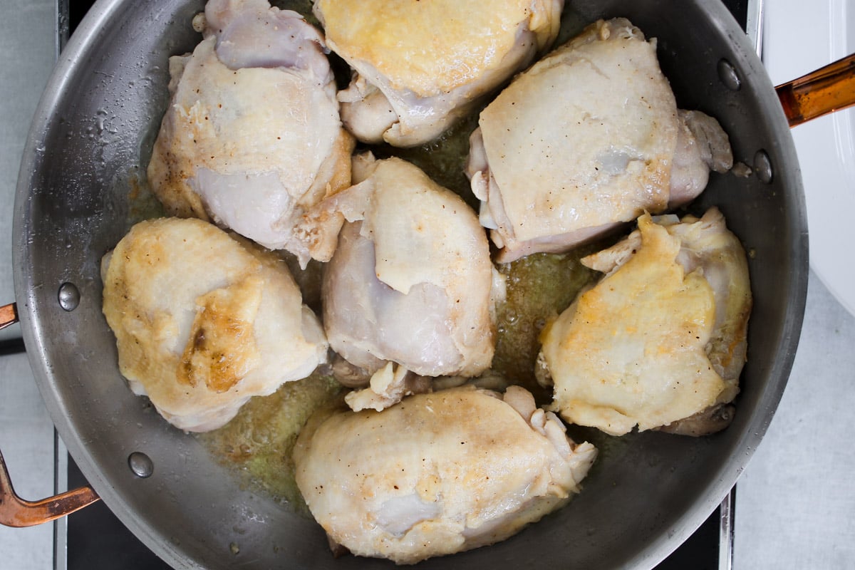 overhead image of cooking chicken in a skillet.