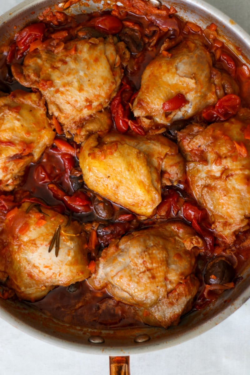 overhead image of chicken cacciatore in a skillet.