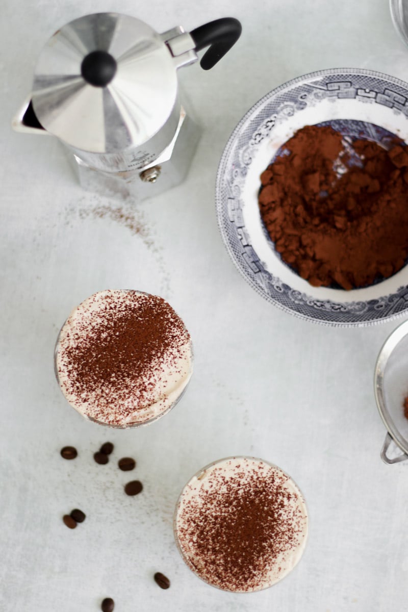 overhead image of Crema al caffè Italian Coffee Cream in glass and cocoa powder.