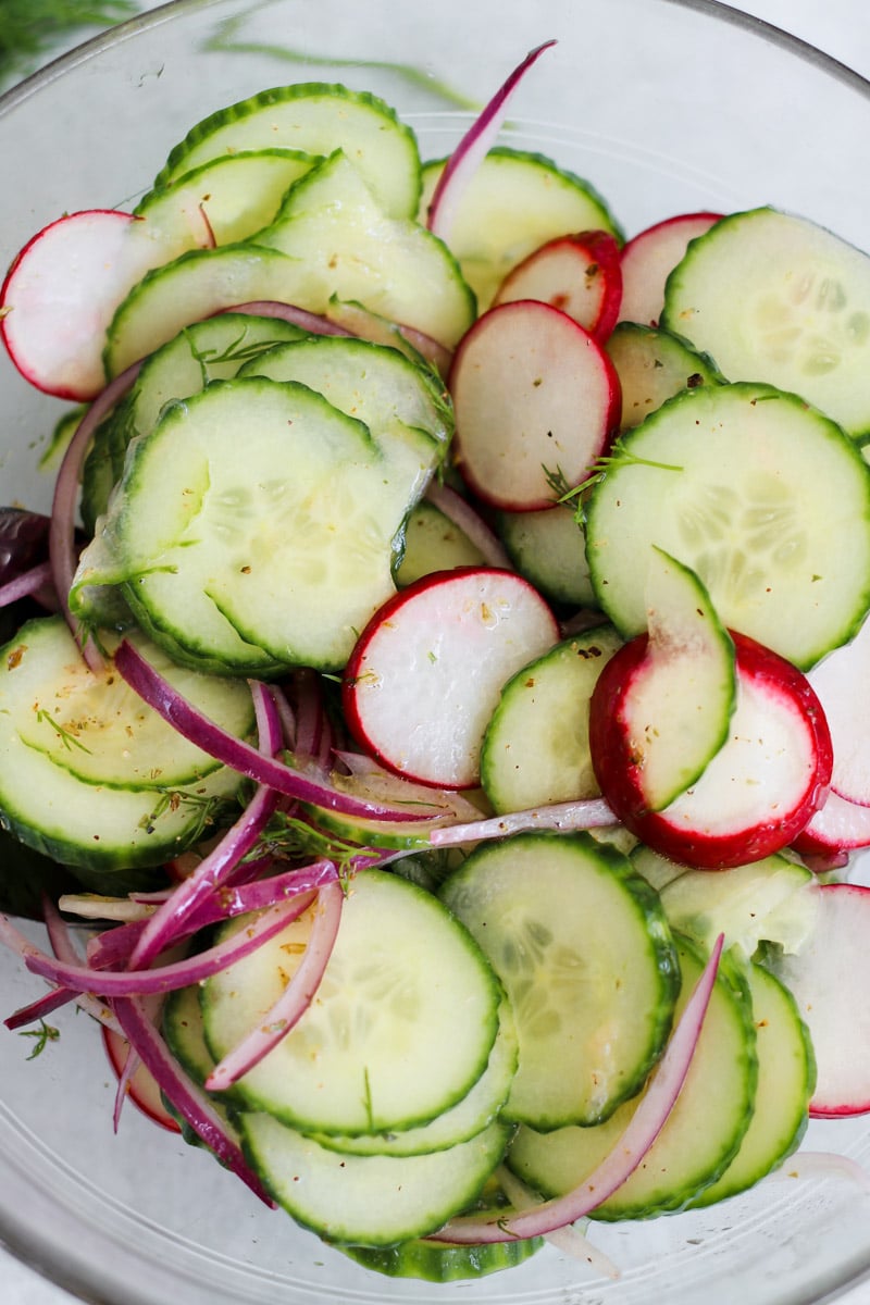 close-up image Mediterranean cucumber salad in a glass bowl.
