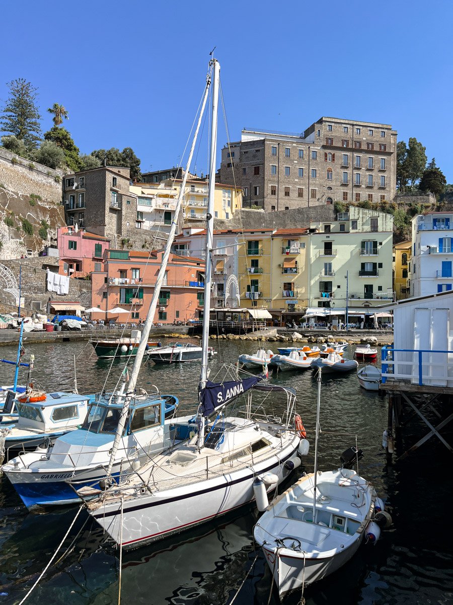 Scenic view of Sorrento coastline with cliffs and colorful buildings overlooking the Bay of Naples