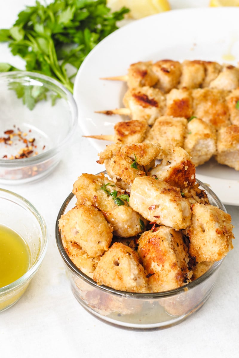 close up image of easy chicken spiedini recipe in oven on a white platter.