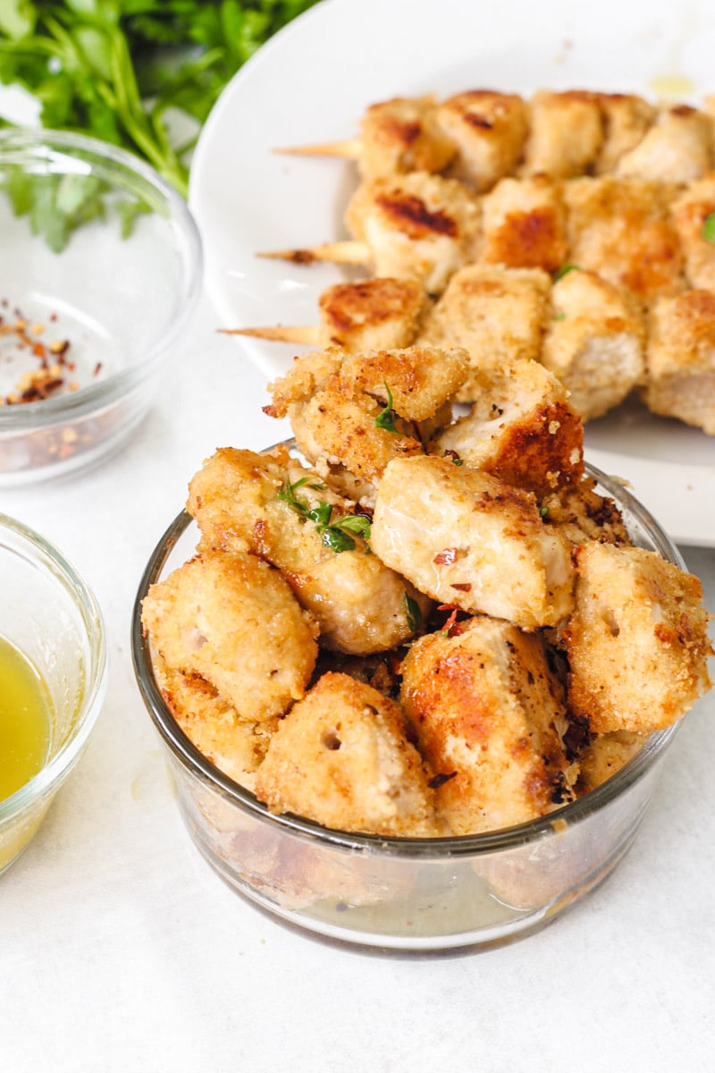 close up image of chicken pieces in a glass bowl.