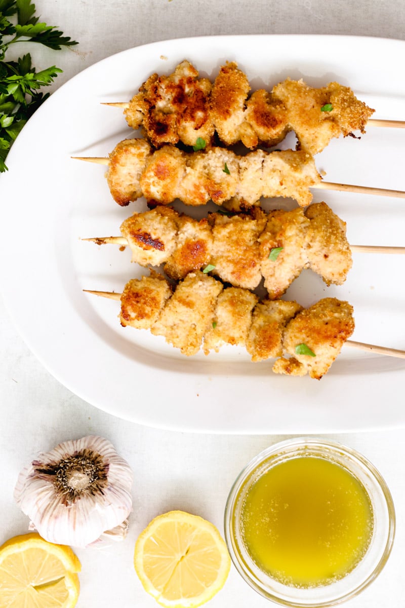 overhead image of chicken spiedini on a white platter.