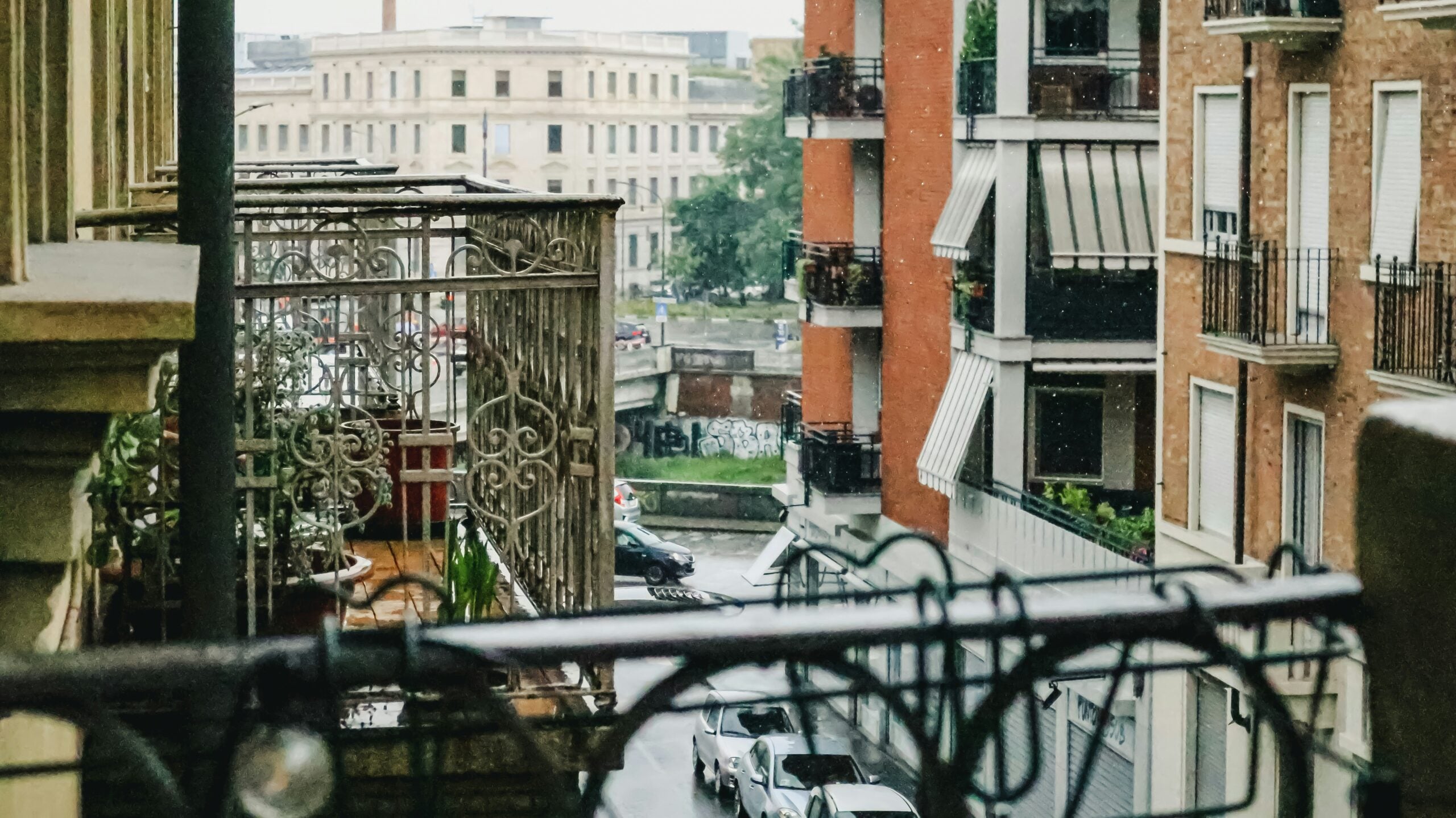 Finding beauty in the raindrops, a serene moment is captured from a balcony on a rainy day in Turin. The soft patter of rain creates a peaceful ambiance, as droplets cling to the railing and glisten in the muted light. The view overlooks the charming cityscape, where historic buildings and cobblestone streets take on a reflective sheen. Is Turin worth visiting? Absolutely! This tranquil scene highlights the quiet charm and timeless beauty of Turin, making it a perfect destination for those who appreciate the poetic allure of rainy days.