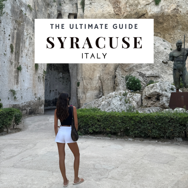 A stunning brunette woman stands gracefully by an ancient building on Ortigia Island in Syracuse, Sicily. The weathered stone façade of the building provides a captivating backdrop, highlighting the rich history and cultural charm of Syracuse. This picturesque scene encapsulates the timeless beauty of Ortigia Island, making it a must-visit destination in Sicily.