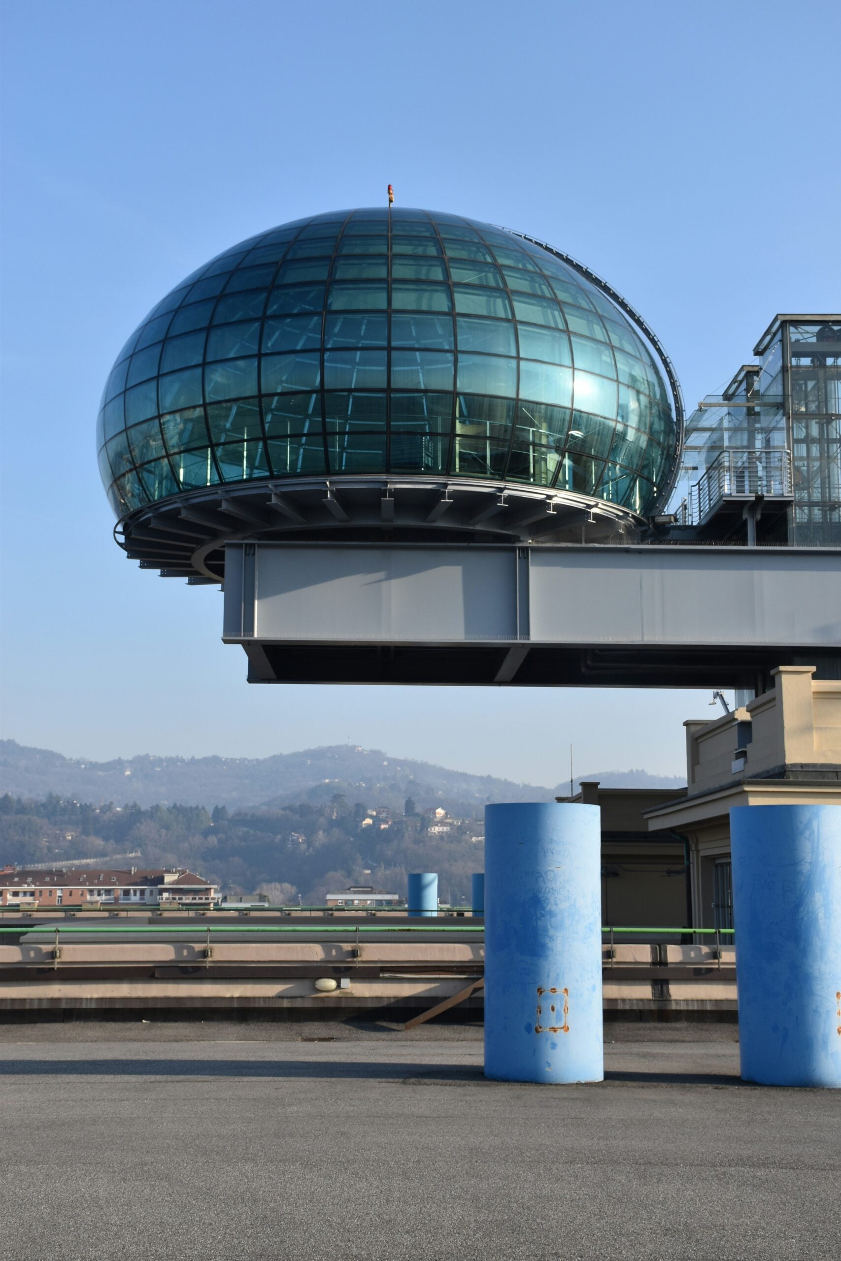 The "Bolla," or bubble, atop the car test track on the roof of the former FIAT car factory in the Lingotto quarter of Turin, Italy, is an iconic landmark. This unique architectural feature, with its glass dome structure, offers panoramic views of the city and the surrounding Alps. Is Turin worth visiting? Absolutely! The Lingotto complex, with its historical significance and innovative design, showcases Turin's industrial heritage and architectural ingenuity, making it a must-see attraction for visitors.