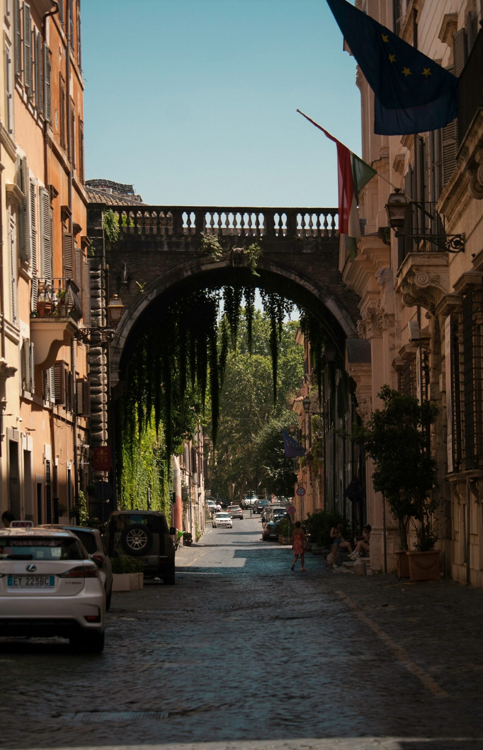 Photograph of one of the coolest streets in Rome, Italy. This vibrant image showcases a lively street filled with bustling cafes, colorful murals, and trendy boutiques. The dynamic atmosphere highlights the unique blend of modern culture and historic charm found in the streets in Rome, Italy. Ideal for travelers seeking a hip and exciting urban experience.