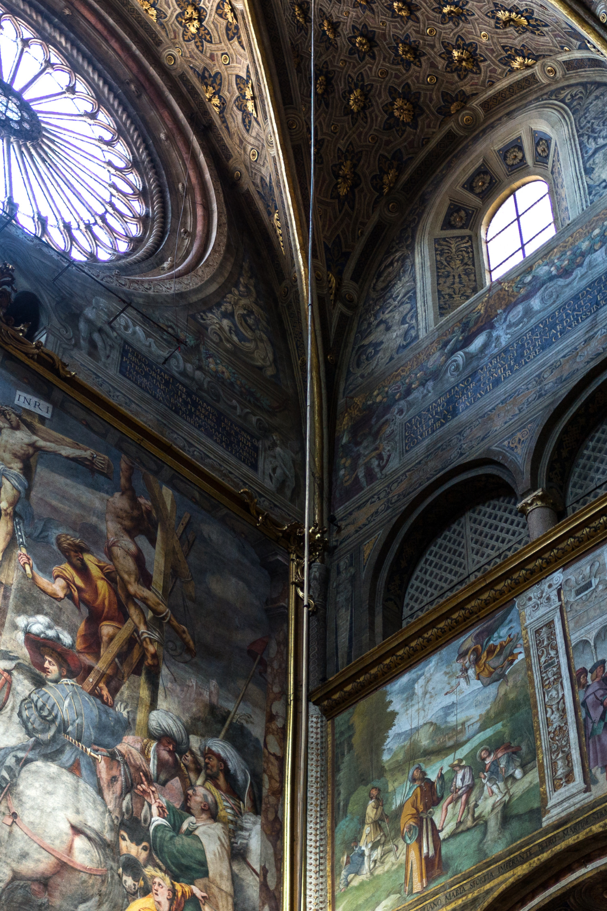 A stunning photograph captures the breathtaking beauty of the frescoes inside the Cremona Cathedral in Cremona, Italy. The interior is adorned with intricate frescoes that depict religious scenes and vibrant biblical stories, their rich colors and fine details creating a sense of awe and reverence. The vaulted ceilings and walls are a canvas of artistic mastery, illuminated by the soft light filtering through stained glass windows. The intricate architecture, featuring ornate columns, arches, and gold accents, adds to the grandeur of the space. This image beautifully showcases the artistic and architectural splendor of the Cremona Cathedral, a testament to the city's rich cultural heritage.