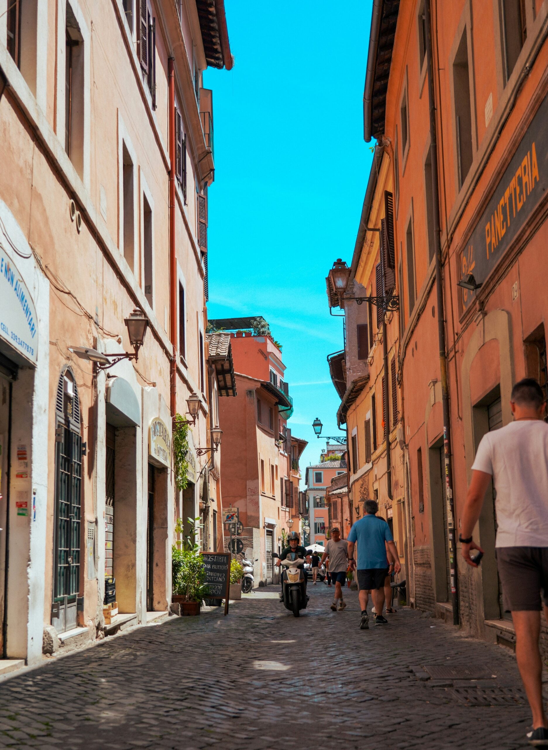Photograph of one of the coolest streets in Rome, Italy, showcasing a lively and vibrant scene. This captivating image features trendy boutiques, chic cafes, and artistic street murals, embodying the contemporary and dynamic spirit of streets in Rome, Italy. Perfect for travelers seeking to experience the modern and stylish side of Rome's urban landscape.