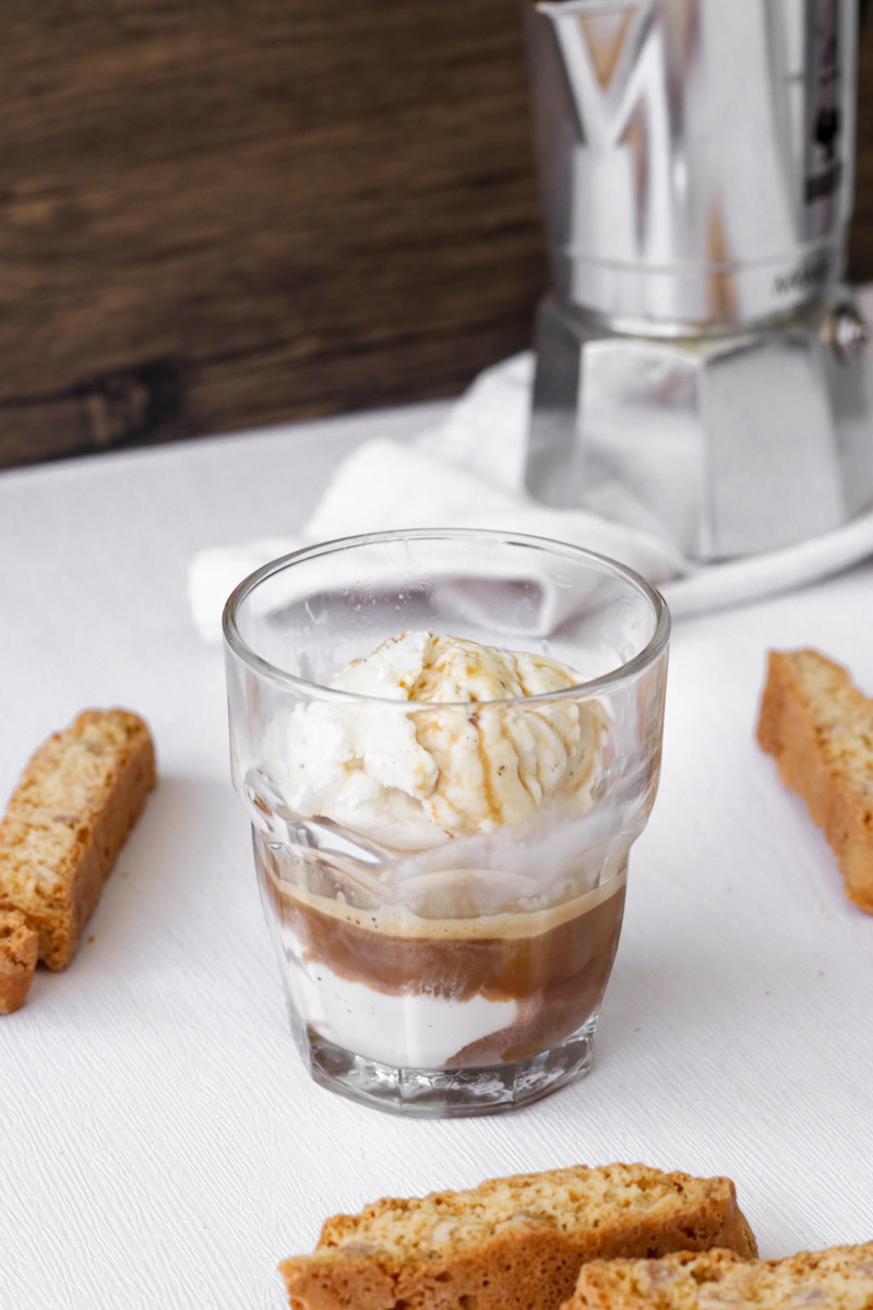 close up image of affogato in a glass and biscotti in background. 