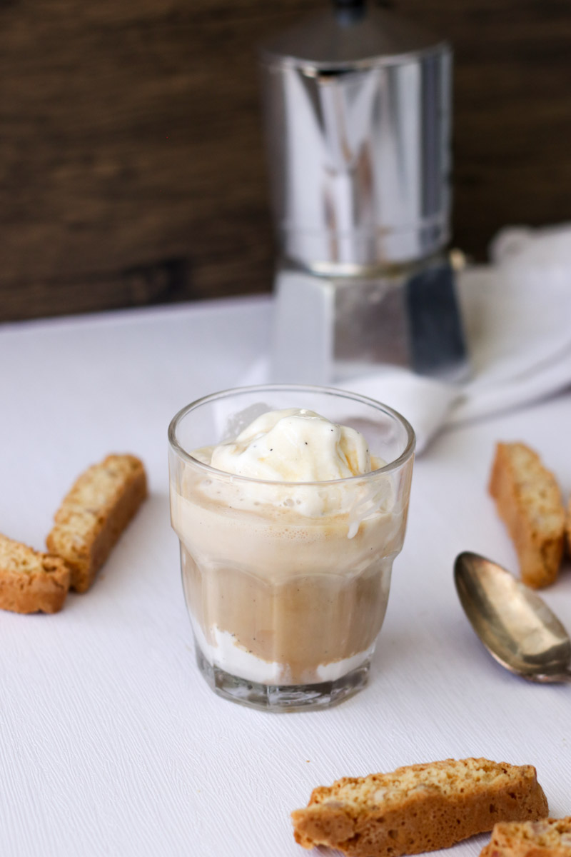 close up image of affogato in a glass with cookies in background. 