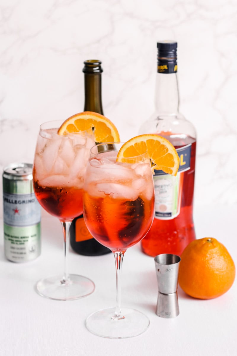 close up image of aperol spritz in glasses.